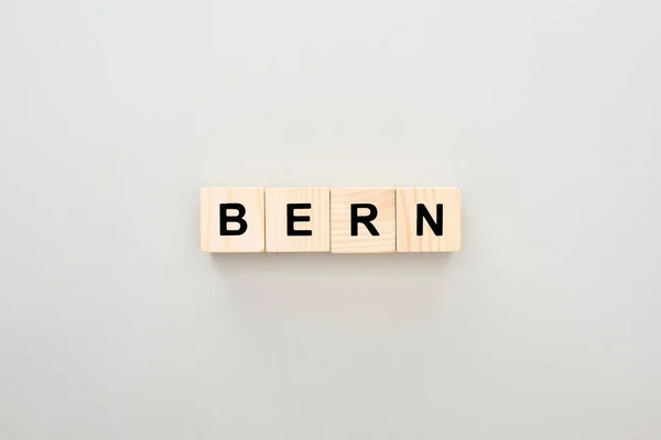 Top view of wooden blocks with Bern lettering on grey background — Stock Photo