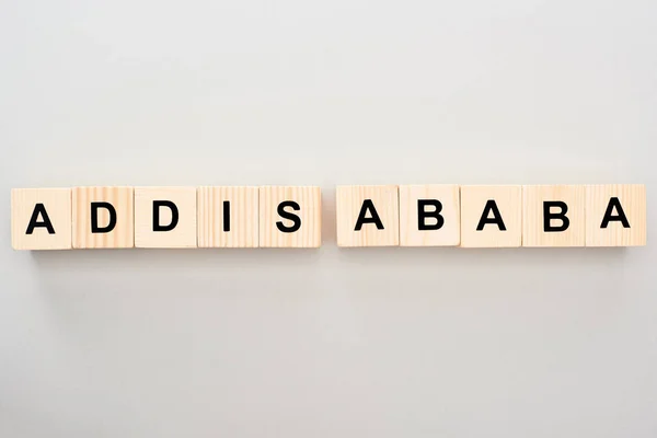 Top view of wooden blocks with Addis Ababa lettering on grey background — Stock Photo