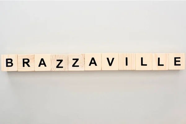 Top view of wooden blocks with Brazzaville lettering on grey background — Stock Photo