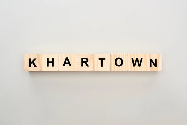 Top view of wooden blocks with Khartown lettering on grey background — Stock Photo