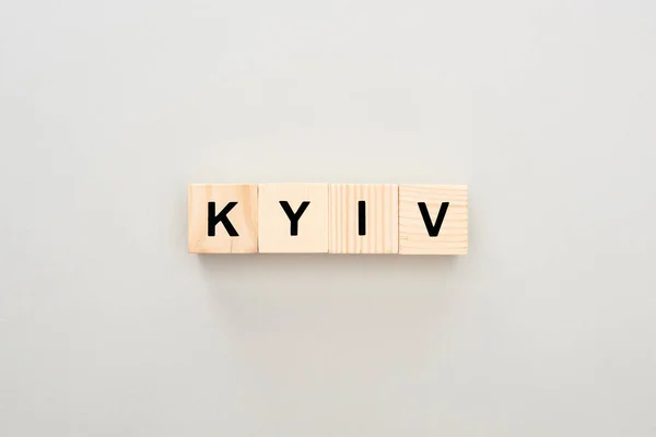 Top view of wooden blocks with Kyiv lettering on grey background — Stock Photo