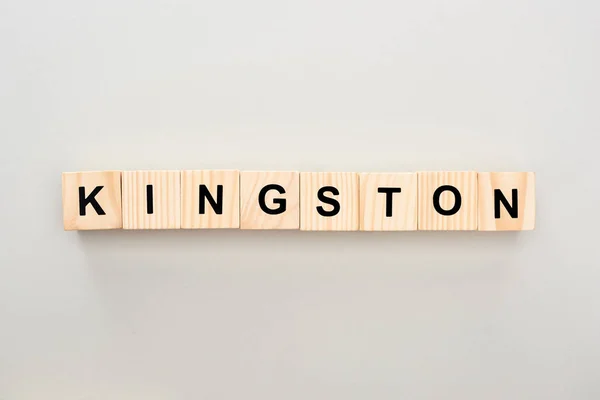 Top view of wooden blocks with Kingston lettering on grey background — Stock Photo