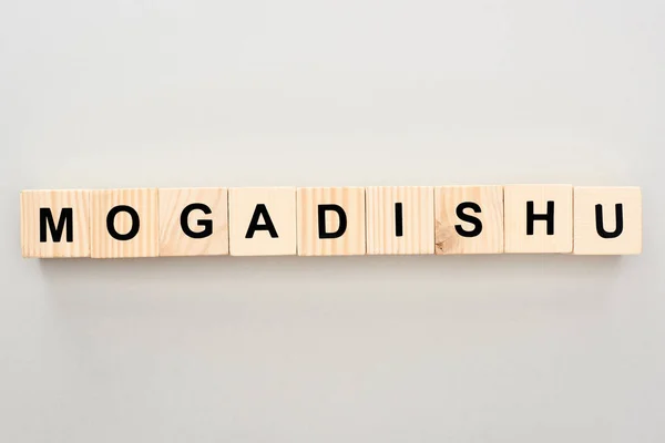Top view of wooden blocks with Mogadishu lettering on grey background — Stock Photo