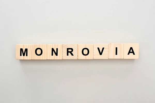 Top view of wooden blocks with Monrovia lettering on grey background — Stock Photo