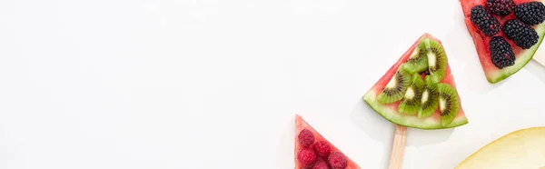 Panoramic shot of delicious watermelon on sticks with berries and kiwi on white background with copy space — Stock Photo