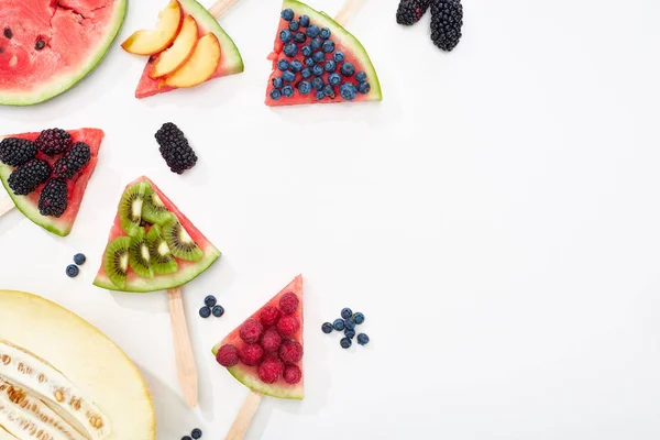 Draufsicht auf köstliche Wassermelonen-Sticks mit saisonalen Beeren und Früchten auf weißem Hintergrund mit Kopierfläche — Stockfoto