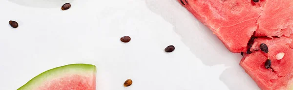 Panoramic shot of fresh watermelon and seeds on white background — Stock Photo