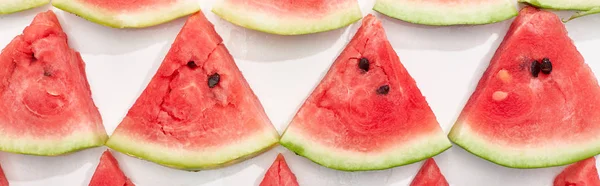 Panoramic shot of fresh watermelon slices in rows on white background — Stock Photo