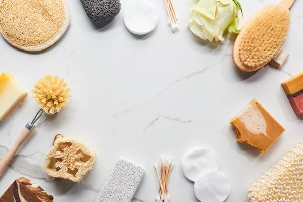 Top view of homemade soap, bathroom accessories and flower on marble surface with copy space — Stock Photo