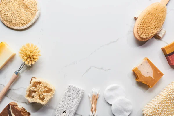 Top view of homemade soap and bathroom accessories on marble surface with copy space — Stock Photo