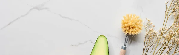 Panoramic shot of body brush and dry branch with small flowers on marble surface — Stock Photo