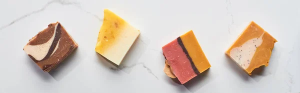 Panoramic shot of natural homemade soap pieces on marble surface — Stock Photo