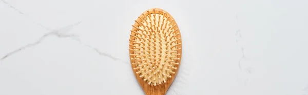 Panoramic shot of hair brush on white marble surface — Stock Photo