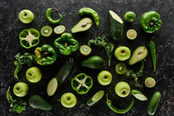 Top view of apples, avocados, cucumbers, kiwi, limes, peppers, greenery and zucchini — Stock Photo