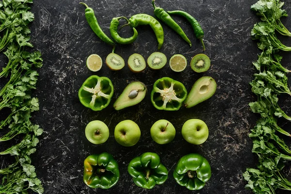Top view of apples, avocados, cucumbers, limes, kiwi, peppers, greenery — Stock Photo