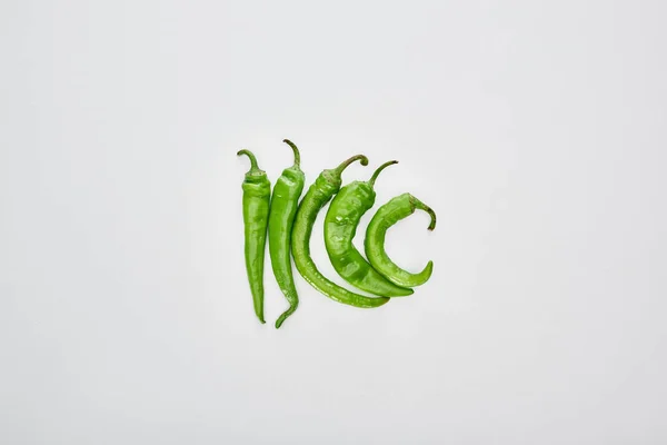 Top view of fresh and green peppers on white background — Stock Photo