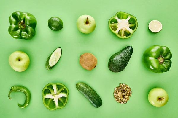 Top view of apples, avocado, cucumbers, limes, peppers, kiwi and pumpkin seeds — Stock Photo