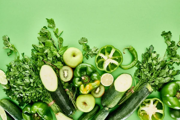 Top view of apples, cucumbers, lime, peppers, kiwi greenery and zucchini — Stock Photo