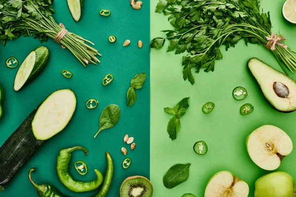 Top view of apples, avocado, cucumbers, peppers, kiwi, greenery, pumpkin seeds and zucchini — Stock Photo