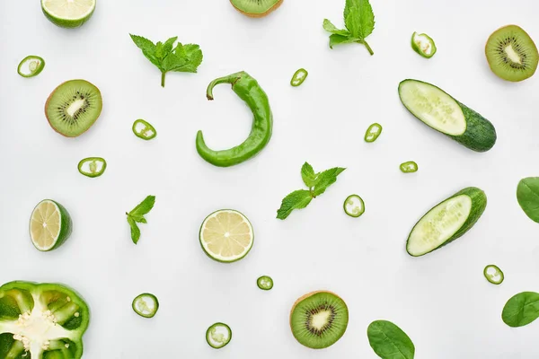 Vue de dessus des concombres frais, kiwi, chaux, poivrons et verdure — Photo de stock