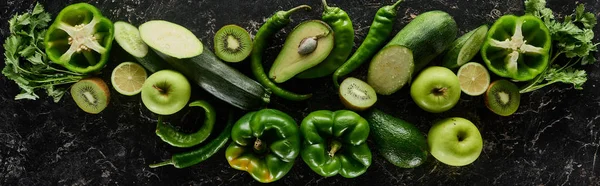 Panoramic shot of fresh apples, limes, peppers, cucumbers, avocados, greenery, kiwi and zucchini — Stock Photo