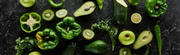 Panoramic shot of fresh apples, lime, peppers, avocados, kiwi, greenery and zucchini — Stock Photo