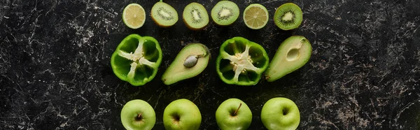 Panoramic shot of fresh apples, limes, peppers, avocados and kiwi — Stock Photo