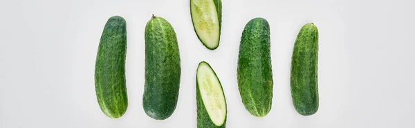 Panoramic shot of fresh and green cucumbers on white background — Stock Photo