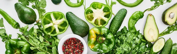 Panoramic shot of spices, peppers, greenery, cucumbers and avocados — Stock Photo