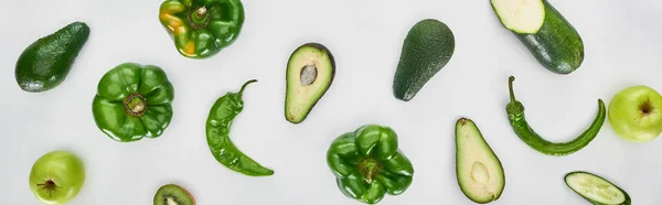 Panoramic shot of peppers, cucumber, apples, zucchini and avocados — Stock Photo