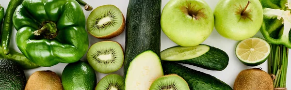Panoramic shot of peppers, cucumbers, zucchini, kiwi, lime, apples and avocado — Stock Photo