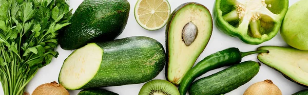 Panoramic shot of peppers, cucumber, zucchini, kiwi, lime, apples and avocados — Stock Photo