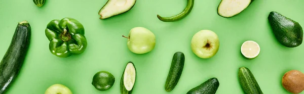 Panoramic shot of peppers, zucchini, kiwi, limes, cucumbers and avocados — Stock Photo