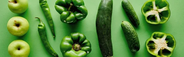 Panoramic shot of fresh and green peppers, zucchini, cucumbers and apples — Stock Photo