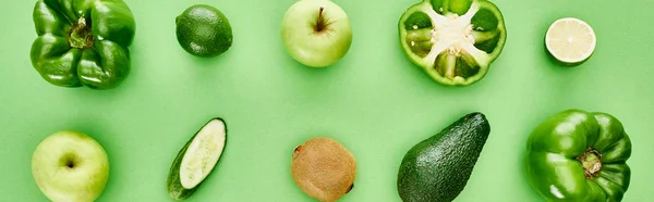 Panoramic shot of peppers, cucumber, kiwi, apples, limes and avocado — Stock Photo