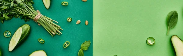 Panoramic shot of fresh and cut cucumbers, peppers and greenery — Stock Photo