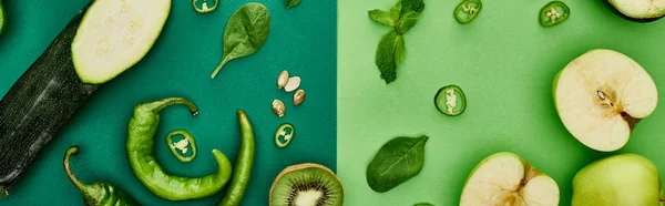 Panoramic shot of apples, zucchini, peppers, kiwi and greenery — Stock Photo