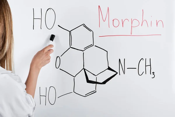 Cropped view of woman pointing with marker at white board — Stock Photo