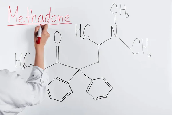 Cropped view of woman writing methadone on white board — Stock Photo