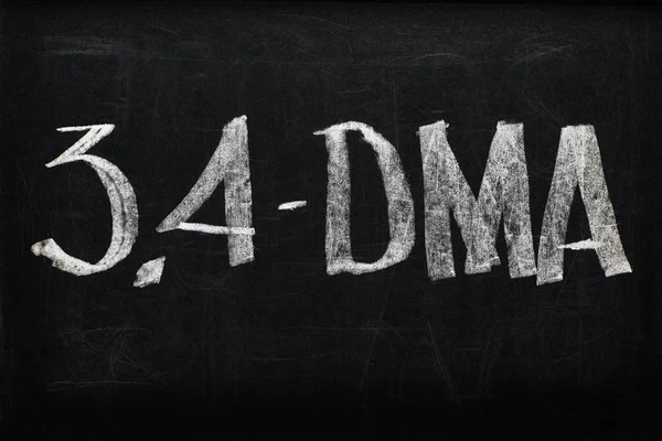 Top view of black chalk board with lettering 3.4-DMA — Stock Photo