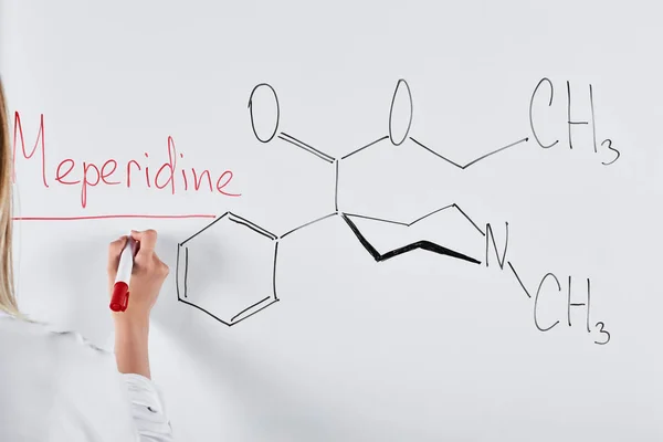 Cropped view of woman writing meperidine on white board — Stock Photo