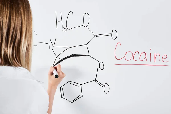 Cropped view of woman writing chemical formula on white board — Stock Photo