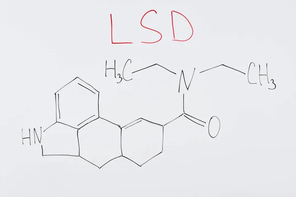 Top view of white board with chemical formula and lettering lsd — Stock Photo