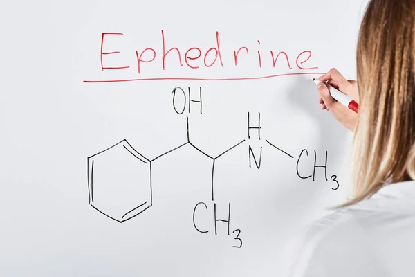 Cropped view of woman writing ephedrine on white board — Stock Photo