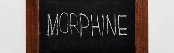 Panoramic shot of black chalk board with lettering morphine — Stock Photo