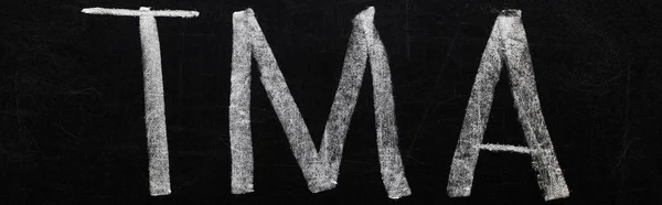 Panoramic shot of black chalk board with lettering tma — Stock Photo