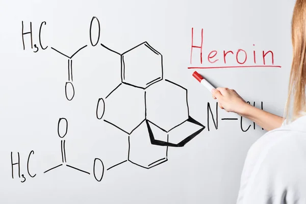 Cropped view of woman pointing with marker at white board — Stock Photo