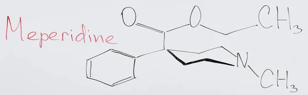 Panoramic shot of white board with chemical formula and lettering meperidine — Stock Photo