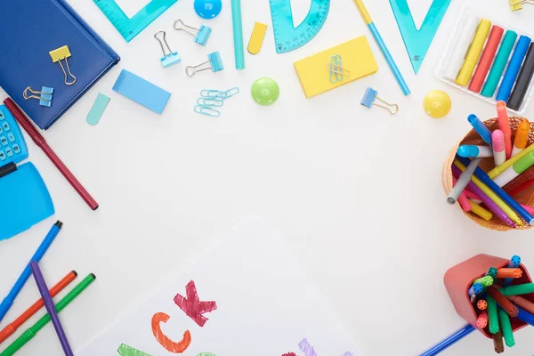 Top view of cup with colorful felt-tip pens and school supplies isolated on white — Stock Photo