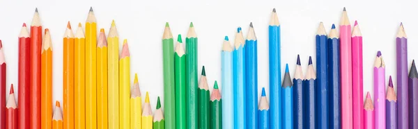 Panoramic shot of line of different sizes color pencils isolated on white — Stock Photo
